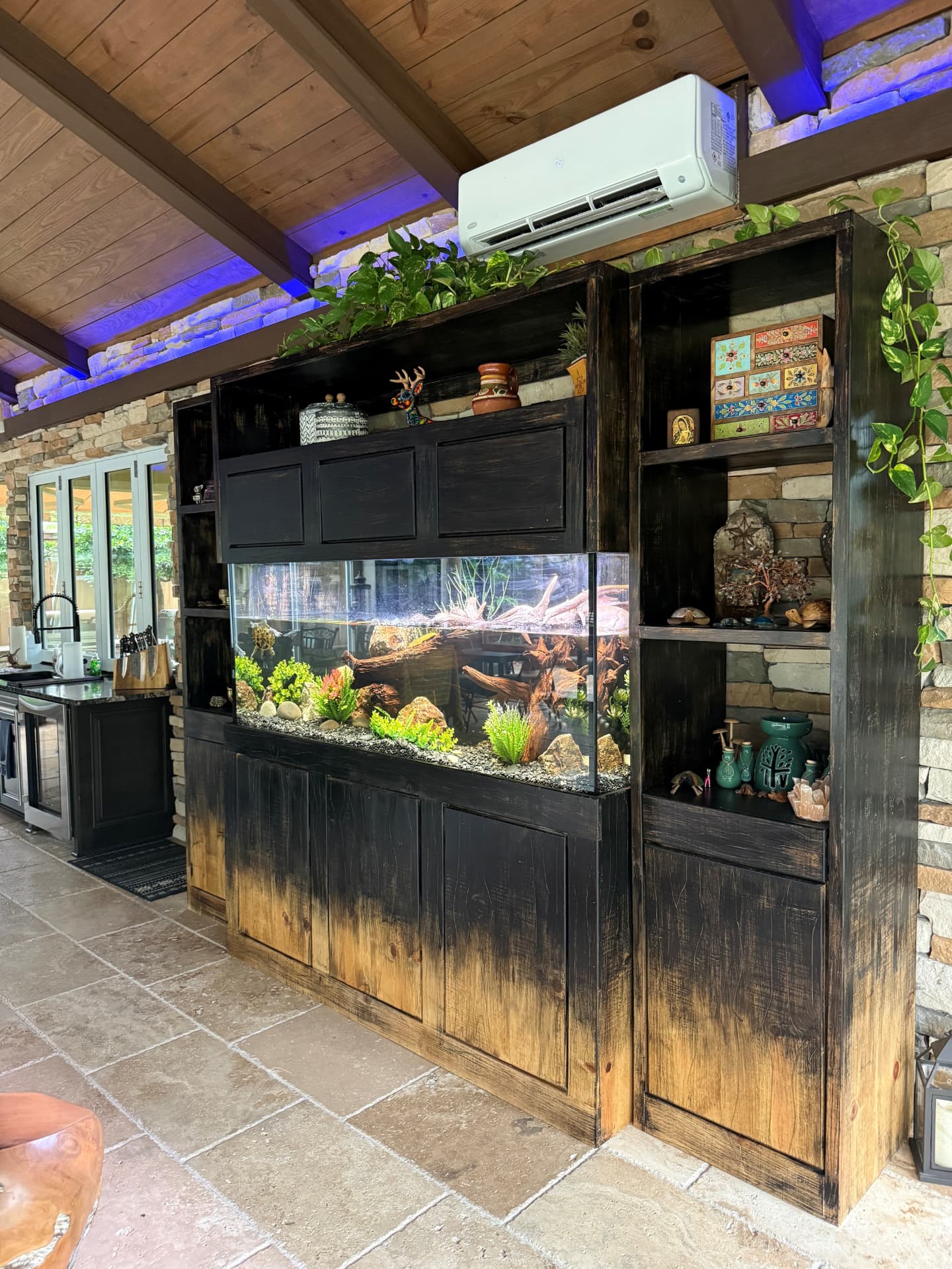 Freshwater aquarium integrated into an outdoor kitchen wall