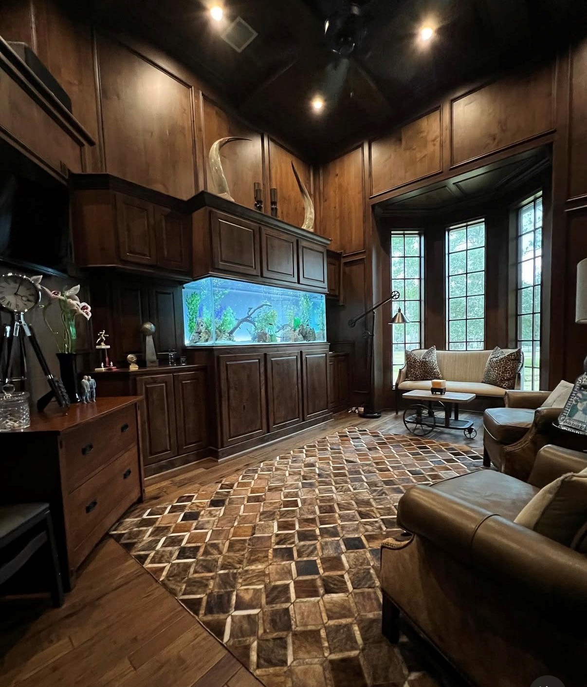 Aquarium built into wood cabinetry in a paneled living room